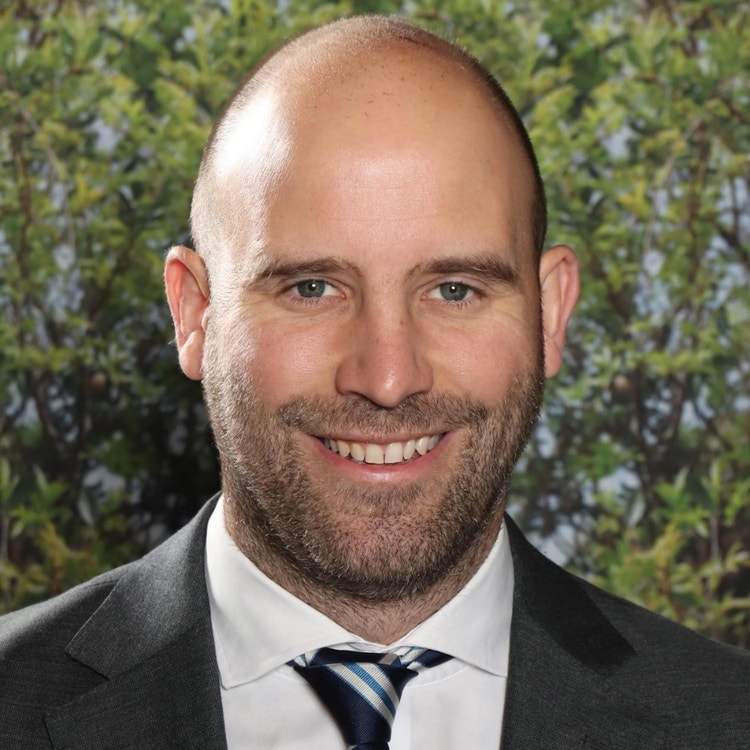 A photo of Nicholas Johnson smiling at the camera.