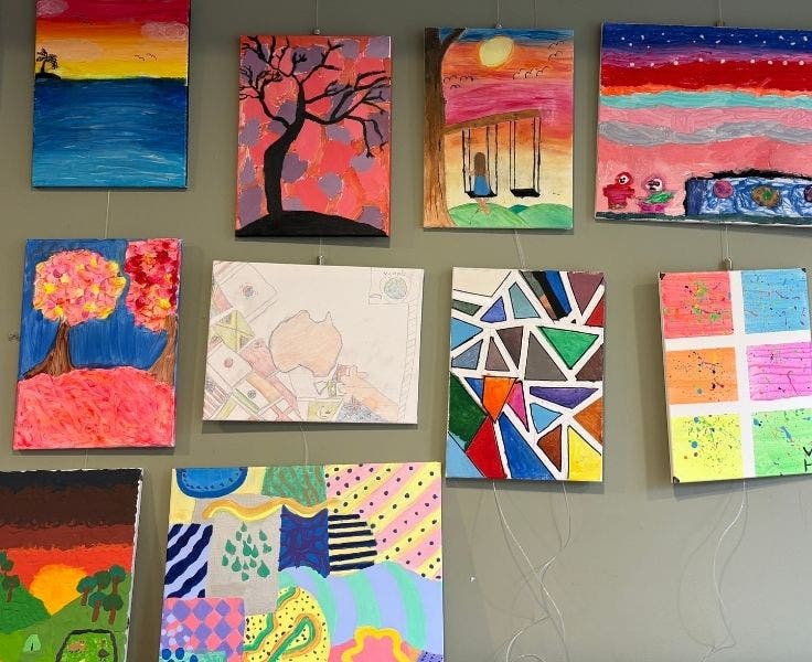 A gallery wall of vibrant student art.